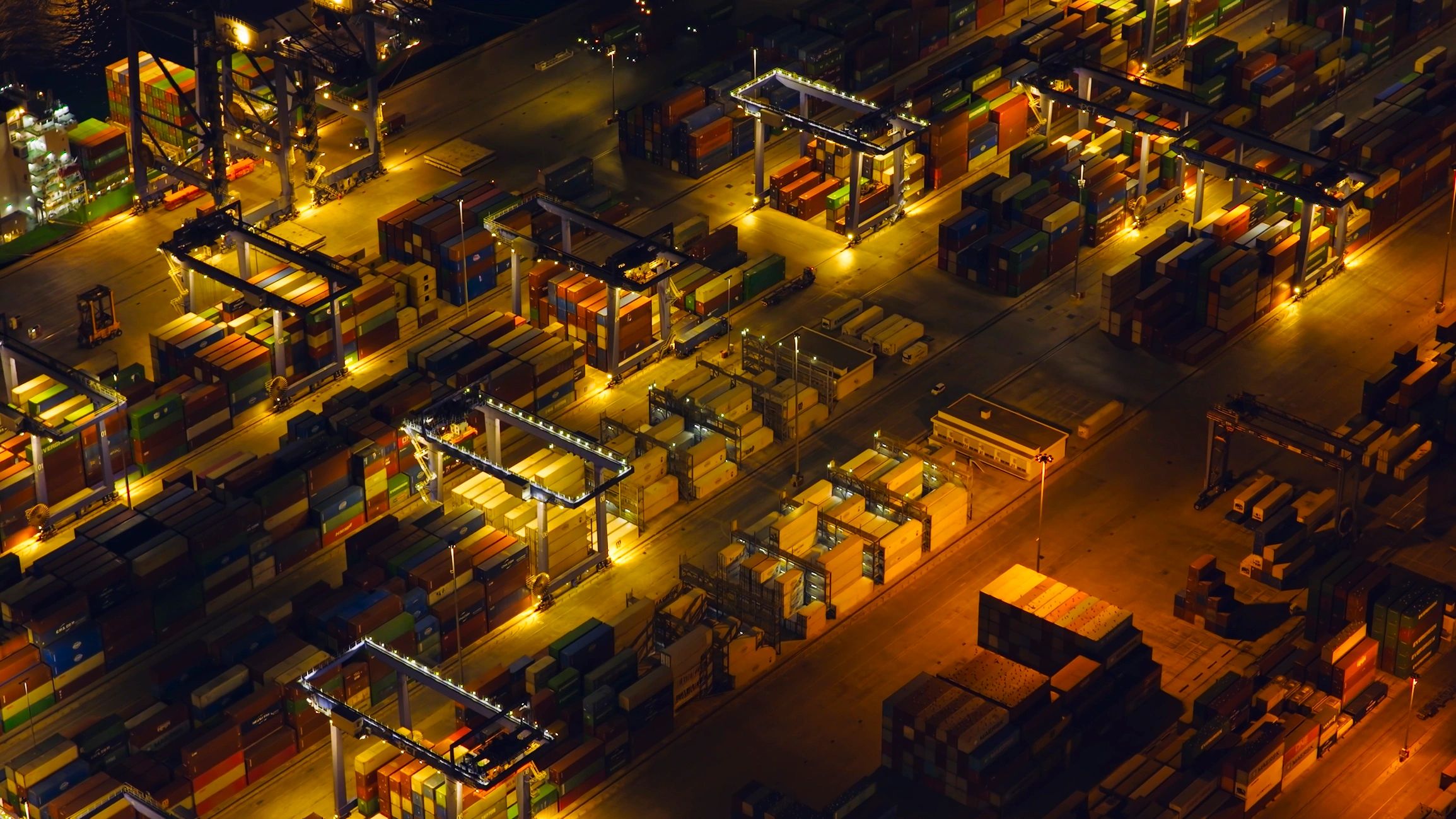 Illuminated cargo terminal showing global logistics operations